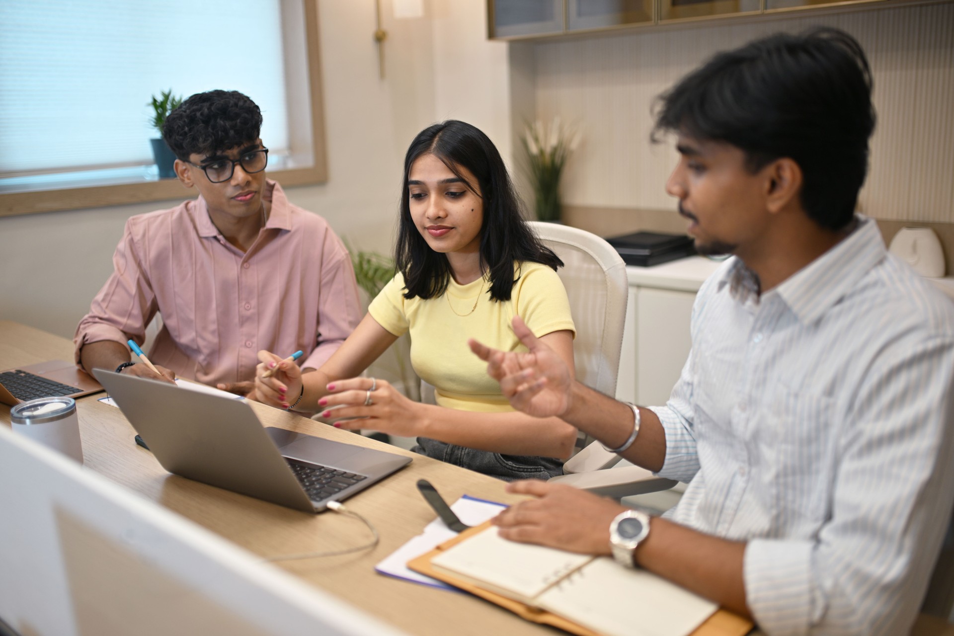 Intense discussion between young colleagues in a modern startup office